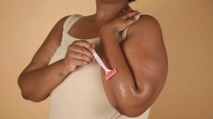 Lifestyle product Carmesi Disposable Body Razor being used for painless hair removal.
